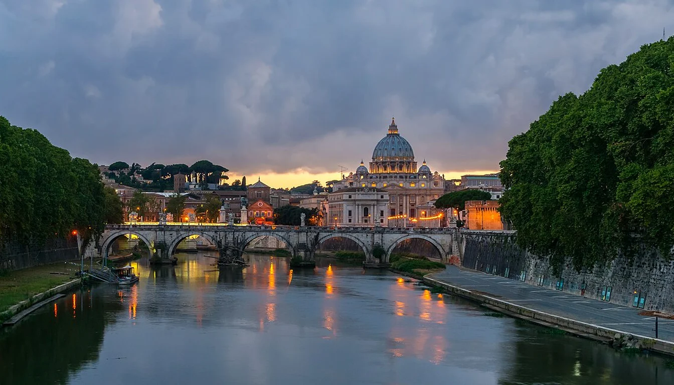 Dusk view across the Tiber toward Ponte Sant'Angelo and the dome of St Peter's